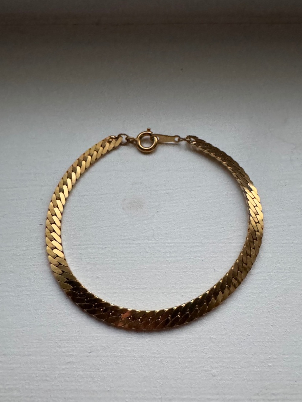 Small herringbone gold tone bracelet